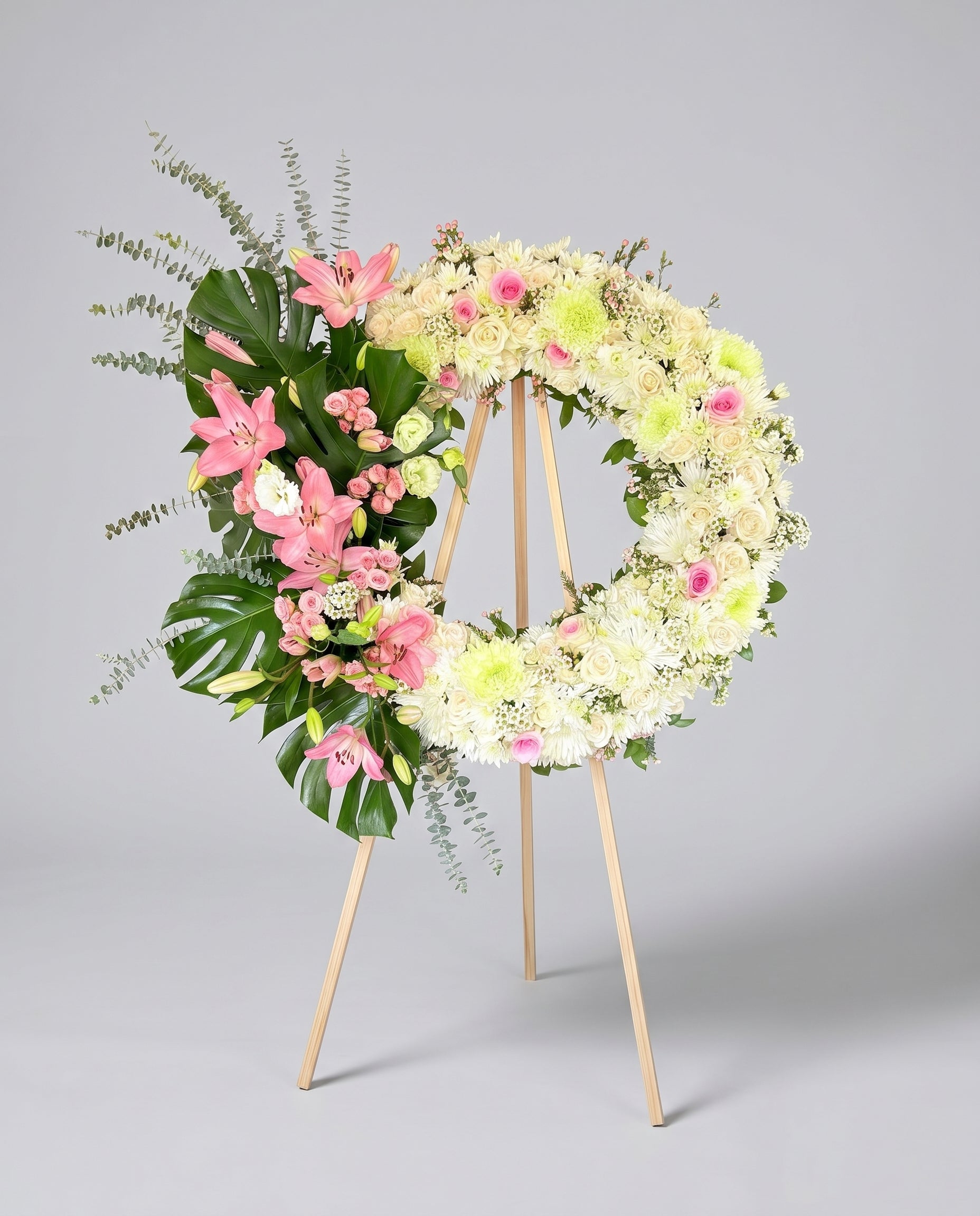 Floral wreath with pink and white flowers on a gray background